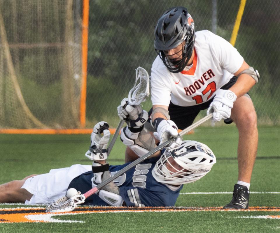 Hoover’s Bryce Roach goes for the ball over Hudson’s Jack  Jenkins in a Division I regional semifinal, Tuesday, May 23, 2023.