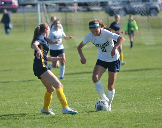 Alivia Zaremba pushes the ball up the field during a high school soccer MHSAA district quarterfinal matchup between Gaylord and Cadillac on Thursday, May 25 in Cadillac, Mich.