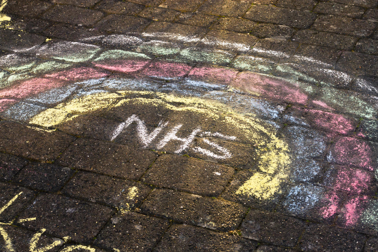 An NHS rainbow drawn on the ground in chalk