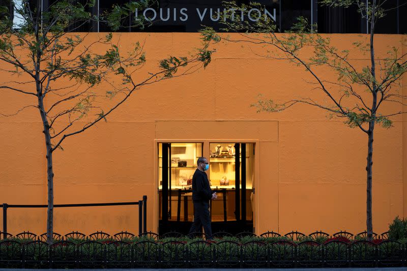 FILE PHOTO: Plywood covers the window of a Louis Vuitton store in Chicago