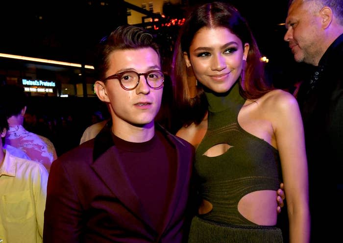 Tom and Zendaya posing together for photos at an event