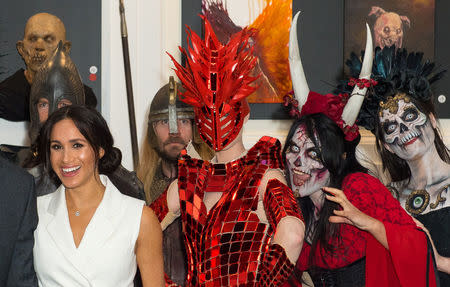 Meghan, the Duchess of Sussex, poses for a photo with actors in costume during a visit to Courtenay Creative, in Wellington, New Zealand October 29, 2018. Dominic Lipinski/Pool via Reuters