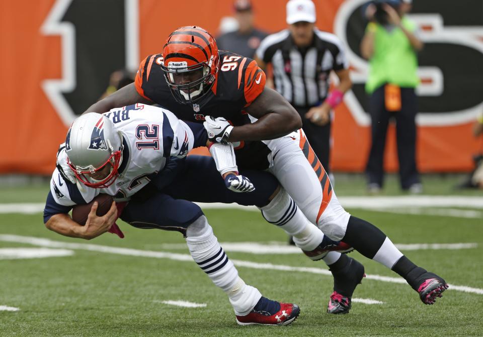 Cincinnati Bengals defensive end Wallace Gilberry (95) sacks New England Patriots quarterback Tom Brady (12) during the first quarter of their game played at Paul Brown Stadium on Sunday, Oct. 6, 2013.