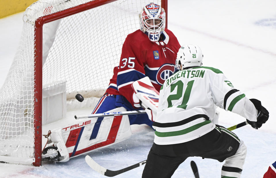 Dallas Stars' Jason Robertson (21) tries to tip the puck past Montreal Canadiens goaltender Sam Montembeault during second period NHL hockey action in Montreal, Canada, Saturday, Feb. 10, 2024. (Graham Hughes/The Canadian Press via AP)