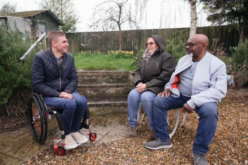 Steve Brown outside in the garden with Rachel and Red from the episode of Escape to the Country