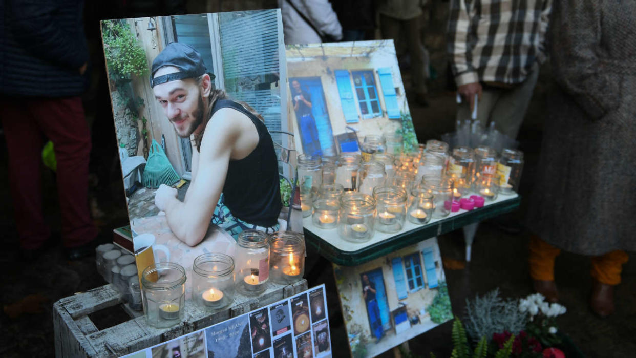 (FILES) In this file photo taken on December 4, 2021 portraits and candles are displayed during a white march to pay tribute to Morgan Keane, a year after he was killed by a hunter, in Cajarc, southwestern France. - The Cahors criminal court will rule on January 12, 2023 on the fate of the hunter who killed Morgan Keane in 2020 in a village in the Lot, after mistaking him for a wild boar, and the person in charge of the hunt. (Photo by Valentine CHAPUIS / AFP)