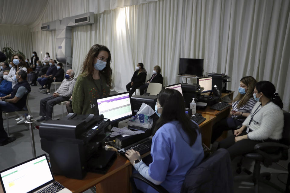 A woman registers to get a Pfizer COVID-19 vaccine at Saint George Hospital University Medical Center, in Beirut, Lebanon, Tuesday, April 6, 2021. Human Rights Watch, a leading rights group, said that Lebanon's vaccination campaign has been slow and risks leaving behind some of the country's most vulnerable people, including Palestinian and Syrian refugees, as well as migrant workers. (AP Photo/Bilal Hussein)