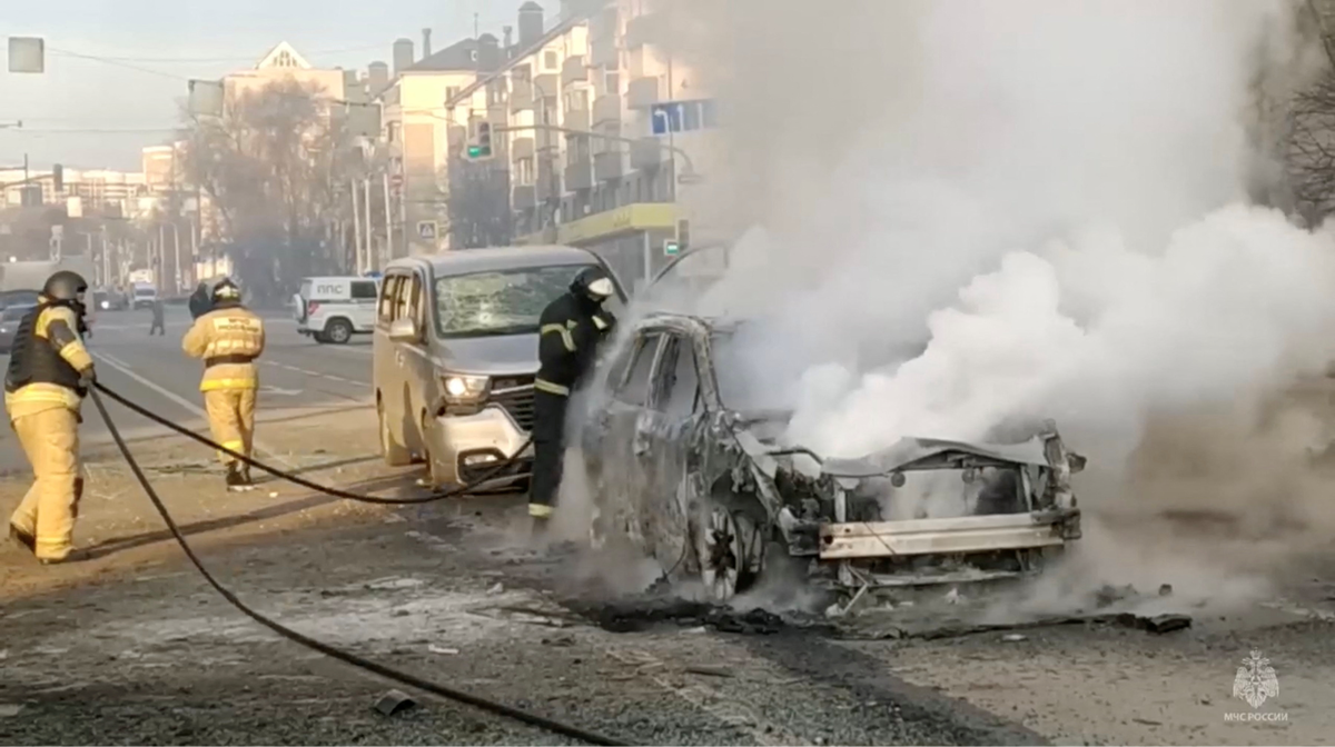 Firefighters extinguish a burning car following shelling in Belgorod (via REUTERS)