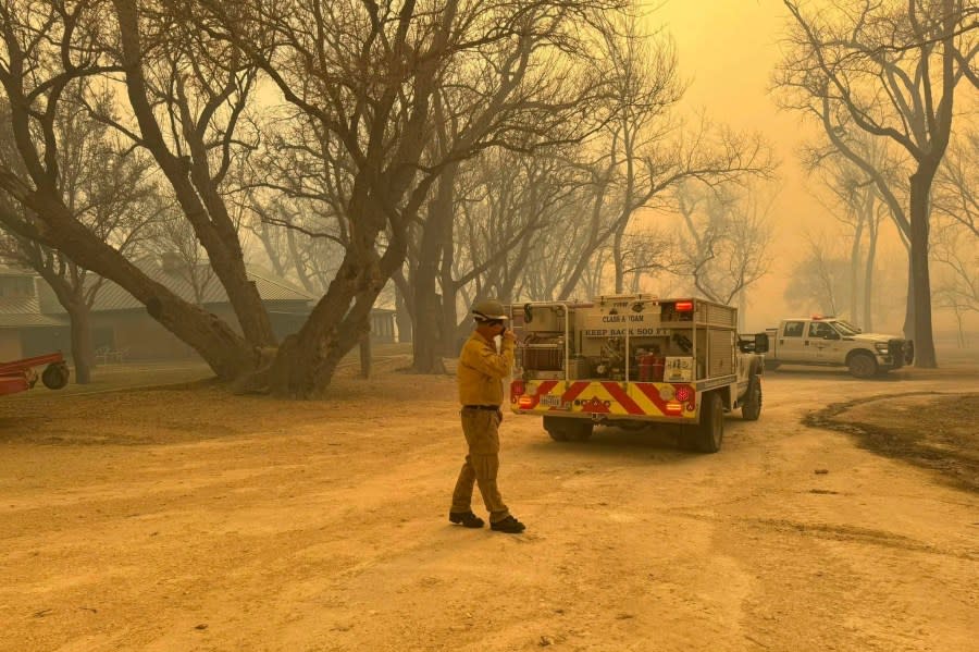 In this photo provided by the Flower Mound, Texas, Fire Department, Flower Mound firefighters respond to a fire in the Texas Panhandle, Tuesday, Feb. 27, 2024. A rapidly widening Texas wildfire doubled in size Tuesday and prompted evacuation orders in at least one small town. (Flower Mound Fire Department via AP)