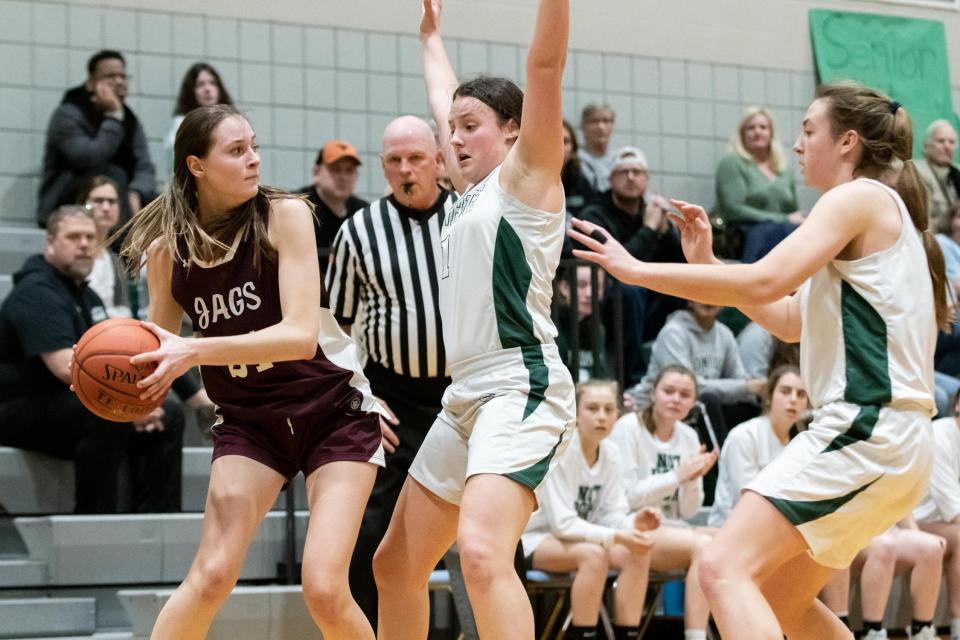 Pennridge's Ella Brown, center, and Katie Yoder guard Garnet Valley's Katie Dwyer in a District One Class 6A first round playoff game at Pennridge High School in Perkasie on Friday, February 17, 2023. The Jaguars defeated the Rams 45-42.