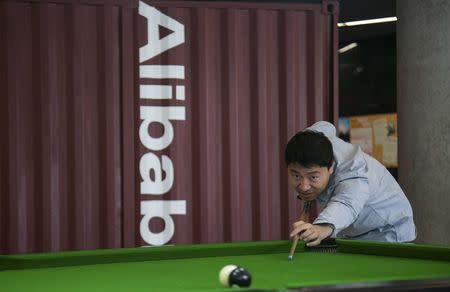 A man plays snooker in a hall inside Alibaba's headquarters in Hangzhou, Zhejiang province, April 23, 2014. REUTERS/Chance Chan