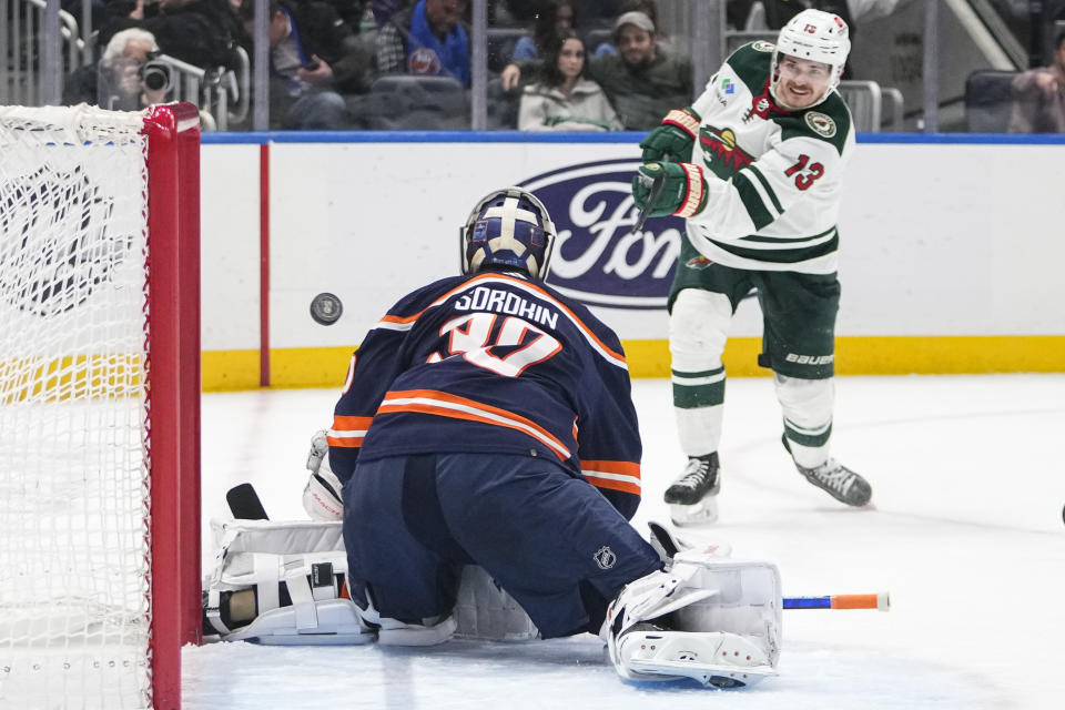 Minnesota Wild's Sam Steel (13) scores against New York Islanders goaltender Ilya Sorokin (30) during the third period of an NHL hockey game Thursday, Jan. 12, 2023, in Elmont, N.Y. The Wild won 3-1. (AP Photo/Frank Franklin II)