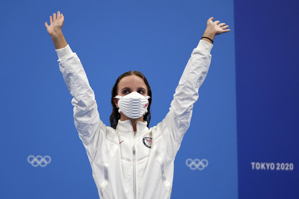 Regan Smith of the United States waves as she stands on the podium to receive her bronze medal for the women's 100-meter backstroke at the 2020 Summer Olympics, Tuesday, July 27, 2021, in Tokyo, Japan. (AP Photo/Matthias Schrader)