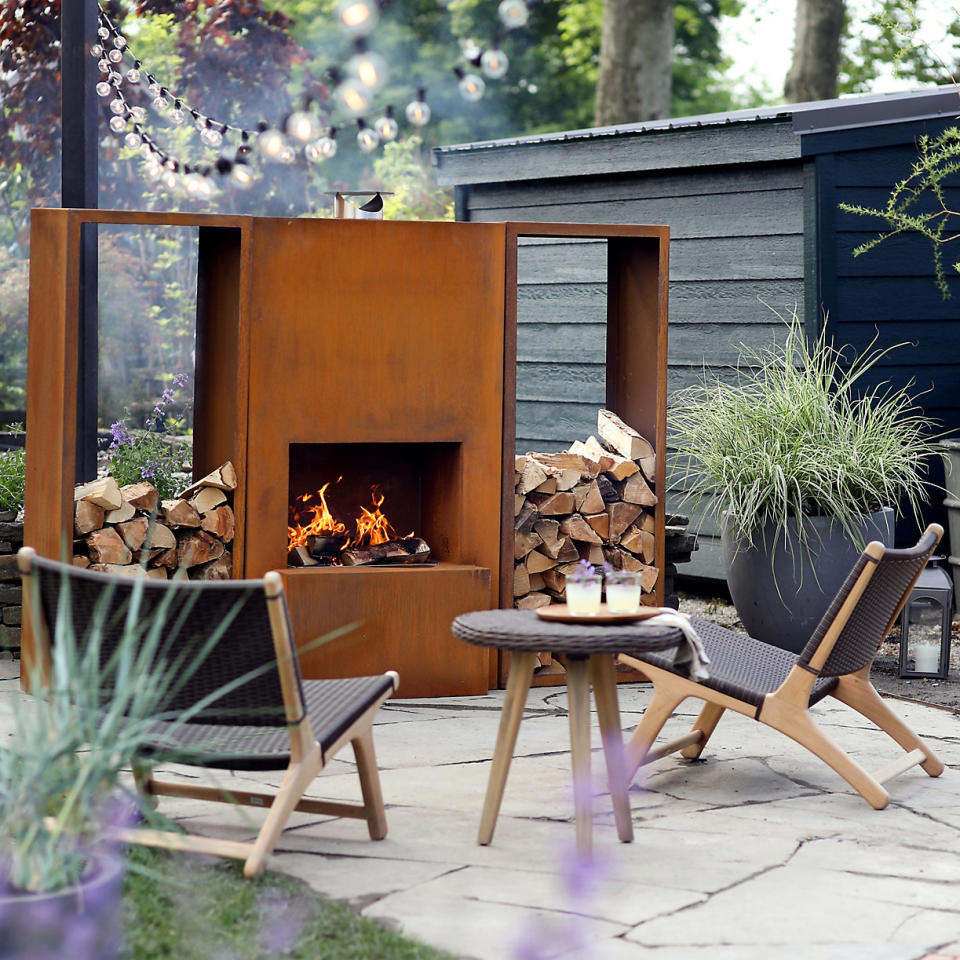 Combine backyard lighting with a fireplace