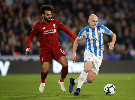 Soccer Football - Premier League - Huddersfield Town v Liverpool - John Smith's Stadium, Huddersfield, Britain - October 20, 2018 Liverpool's Mohamed Salah in action with Huddersfield Town's Aaron Mooy Action Images via Reuters/Carl Recine