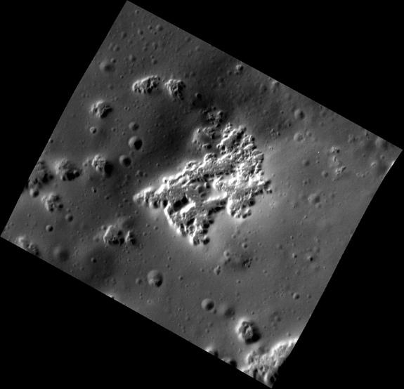 This high-resolution view of Mercury shows hollows — the irregularly shaped, flat-floored depressions — on the southwestern peak ring of the Scarlatti basin. Although there are a number of small impact craters surrounding the hollows, there are