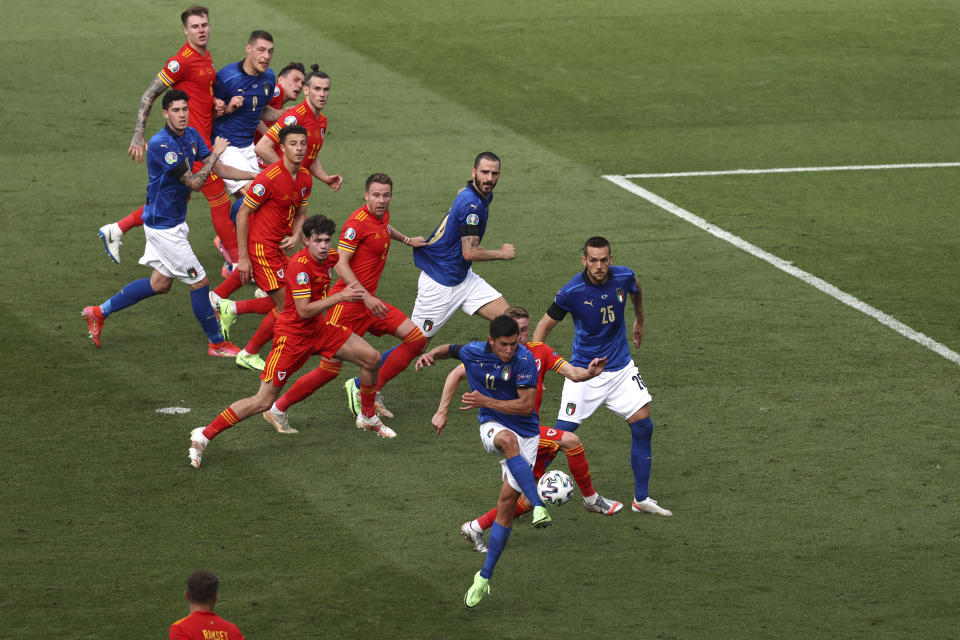 Italy's Matteo Pessina, foreground, scores his side's opening goal during the Euro 2020 soccer championship group A match between Italy and Wales at the Stadio Olimpico stadium in Rome, Sunday, June 20, 2021. (Ryan Pierse/Pool via AP)
