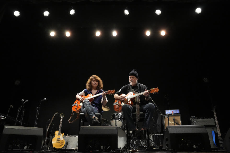 Canadian rock legend Randy Bachman, right, and Japanese musician TAKESHI speak with the media after Bachman reunited with his stolen Gretsch guitar during the Lost and Found Guitar Exchange Ceremony Friday, July 1, 2022, at Canadian Embassy in Tokyo. Bachman’s long-held dream came true Friday when he was reunited in Tokyo with a beloved guitar nearly a half-century after it was stolen from a Toronto hotel. Bachman, 78, a former member of The Guess Who, received the guitar from TAKESHI, a Japanese musician who had bought it at a Tokyo store in 2014 without knowing its history. (AP Photo/Eugene Hoshiko)