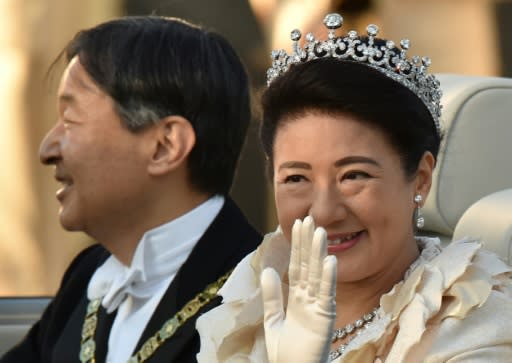 Japan?s Emperor Naruhito and Empress Masako wave during their royal parade in Tokyo