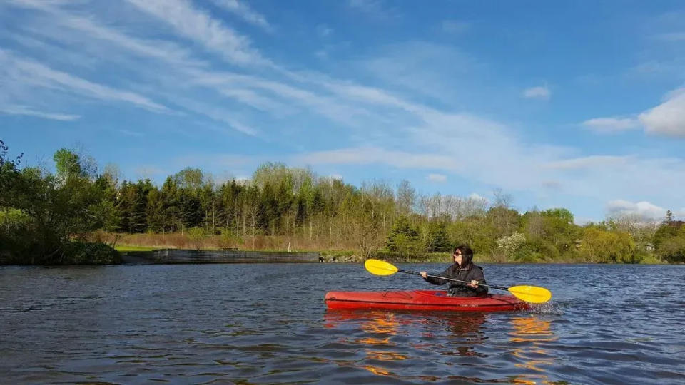 FILE - In this file photo, Nancy Nabak of Woodland Dunes Nature Center and Preserve kayaks the West Twin River.