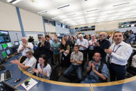 Scientists celebrate the first recorded collisions at 13TeV in CERN's LHC Control Center on June 3, 2015.