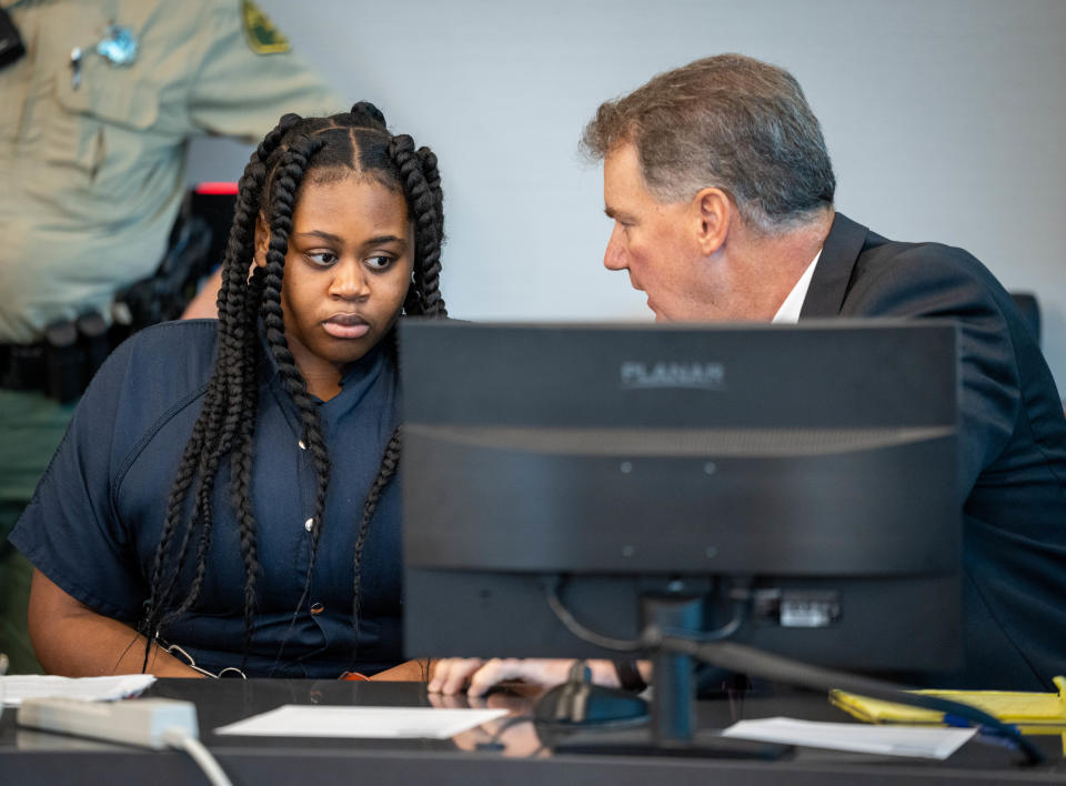 Pieper Lewis speaks with attorney Paul White during a sentencing hearing Wednesday, Sept. 7, 2022. The Des Moines teen pleaded guilty to killing her alleged rapist in June 2020.