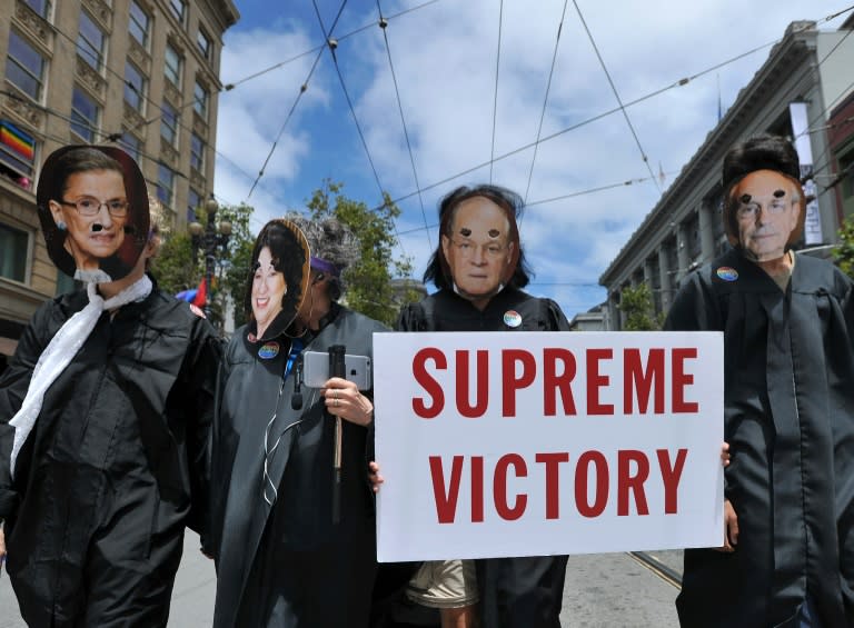 People dressed as United States Supreme Court Justices march along Market Street during the annual Gay Pride Parade in San Francisco, California, on June 28, 2015