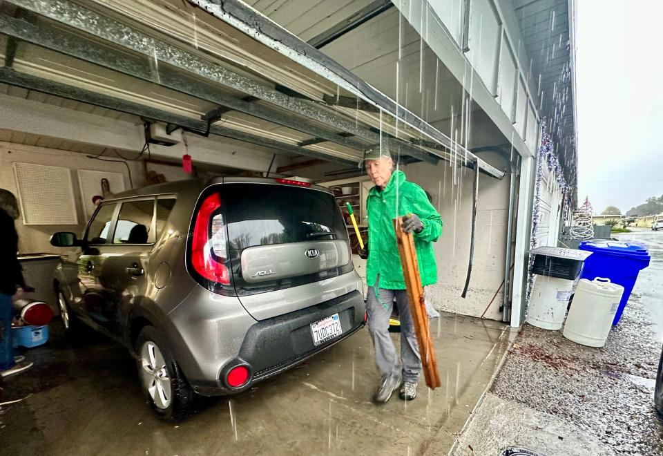 Chris Gray helps her mother move items out of her garage at the Hueneme Bay community in Port Hueneme Thursday, Dec. 21, 2023. The garage was inundated with about 2 feet of water during the worst of the storm.