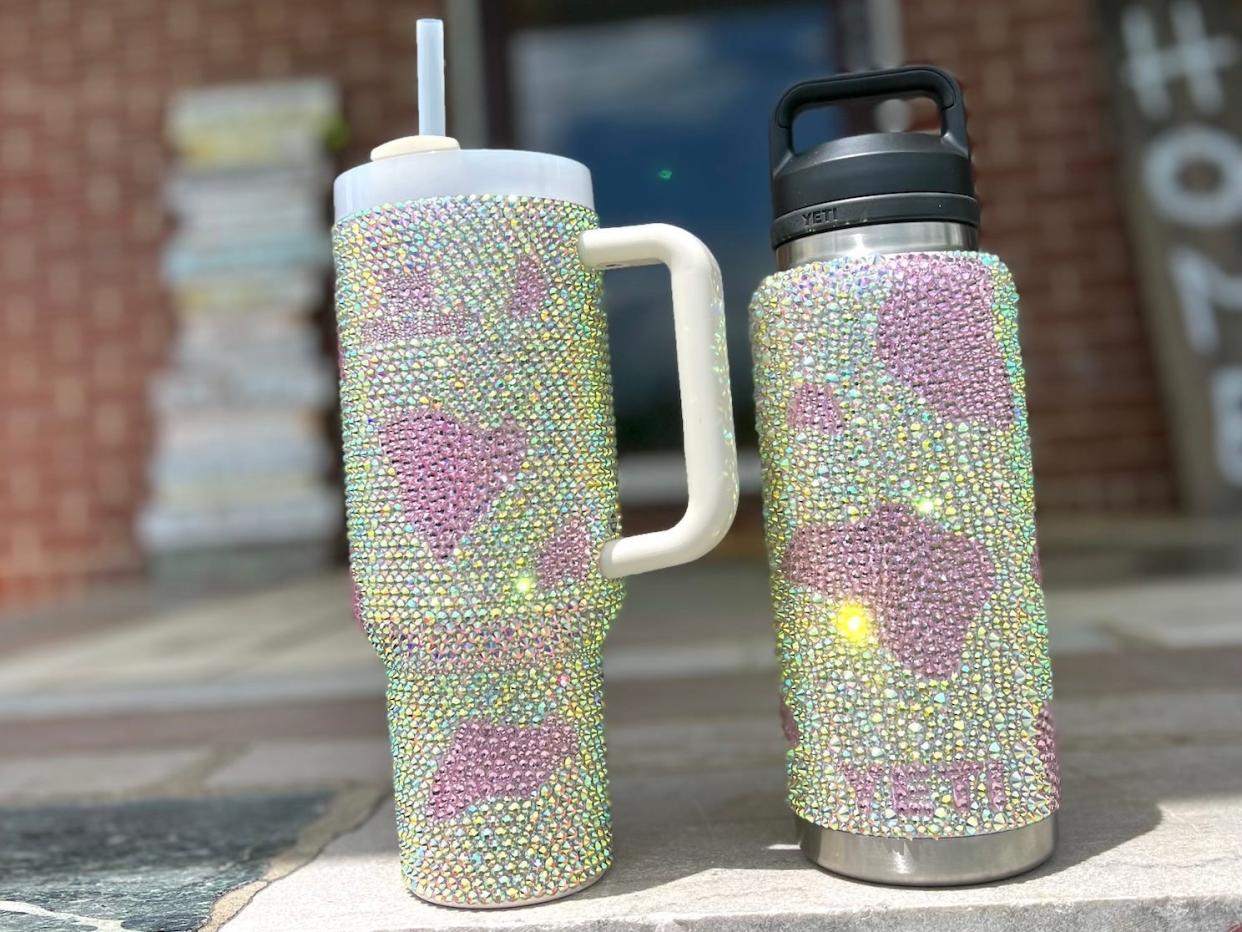 Two Stanley cups bedazzled by Ashley Kosko.