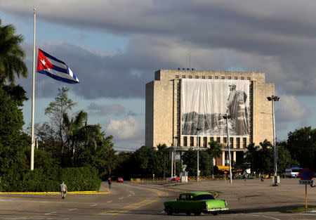 A picture of Cuban former president Fidel Castro hangs in front of the Cuban National Library at Revolution Square in Havana, Cuba November 27, 2016. REUTERS/Enrique de la Osa