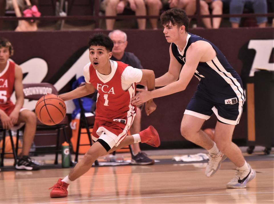 Abilene Cooper's Andrew Gonzalez, left, brings the ball up court for the South team as the North's Kyler Phillips of Lingleville defends in the second half. The South won 89-73 in the Big Country FCA's All-Star Men's Basketball Game on Saturday, June 4, 2022, at Brownwood High School.
