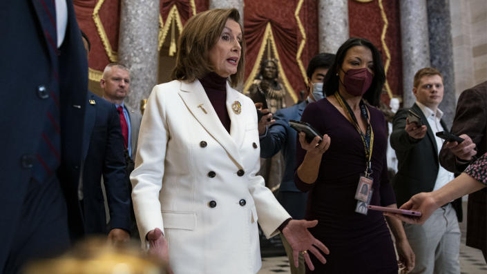 House Speaker Nancy Pelosi, in white suit, after an Equal Pay Day event.