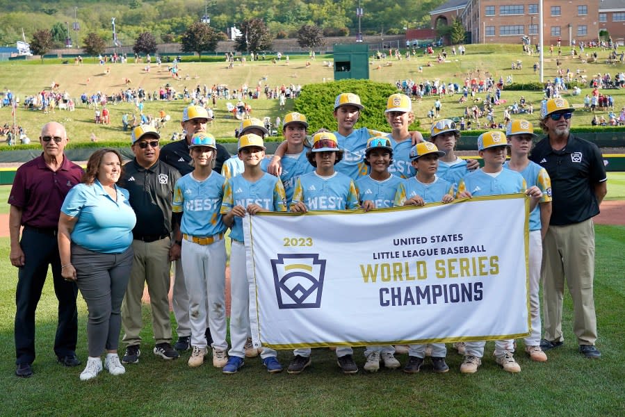 El Segundo, Calif. poses with the championship banner after winning 6-1 against Needville, Texas during United States Championship baseball game at the Little League World Series tournament in South Williamsport, Pa., Saturday, Aug. 26, 2023. (AP Photo/Tom E. Puskar)