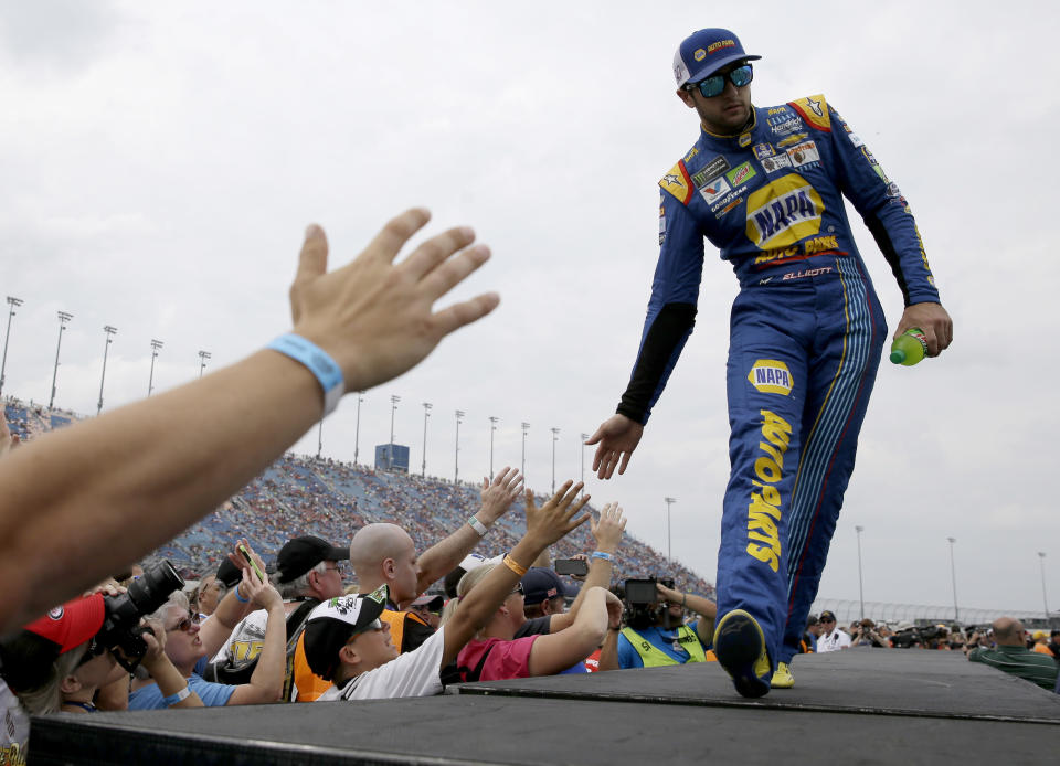 Chase Elliott, right, greets fans before a NASCAR Cup Monster Energy Series auto race at Chicagoland Speedway in Joliet, Ill., Sunday, Sept. 17, 2017. (AP Photo/Nam Y. Huh)