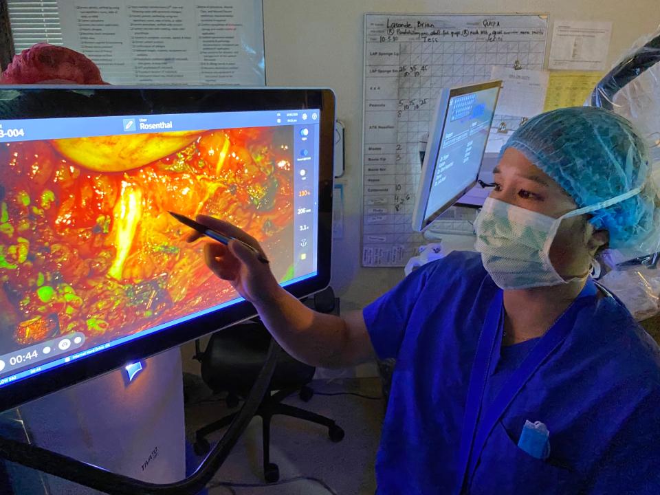 Researcher Marisa Hom points to a nerve that has been colored with a fluorescent dye to make it easier for a surgeon to see.