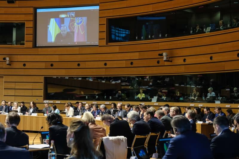 Minister of Defence of Ukraine Rustem Umerov (on screen) speaks during the EU foreign and defence ministers meeting in Luxembourg. Alexandros Michailidis/European Council/dpa