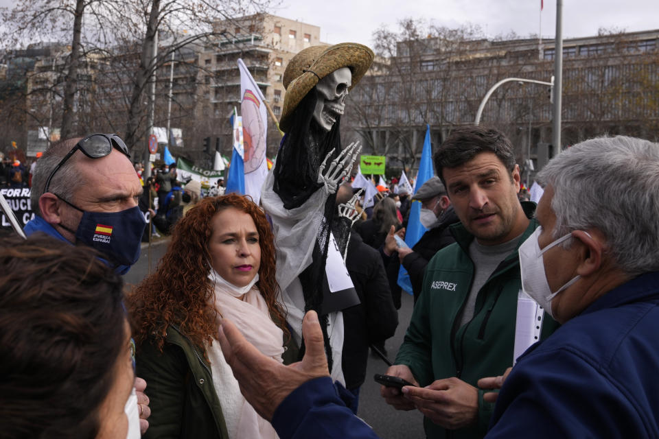 People gather before a protest march along the Castellana Boulevard in Madrid, Spain, Sunday, Jan. 23, 2022, defending Spanish rural areas. Members of rural communities are demanding solutions from the government for problems and crisis in the rural sector. (AP Photo/Paul White)