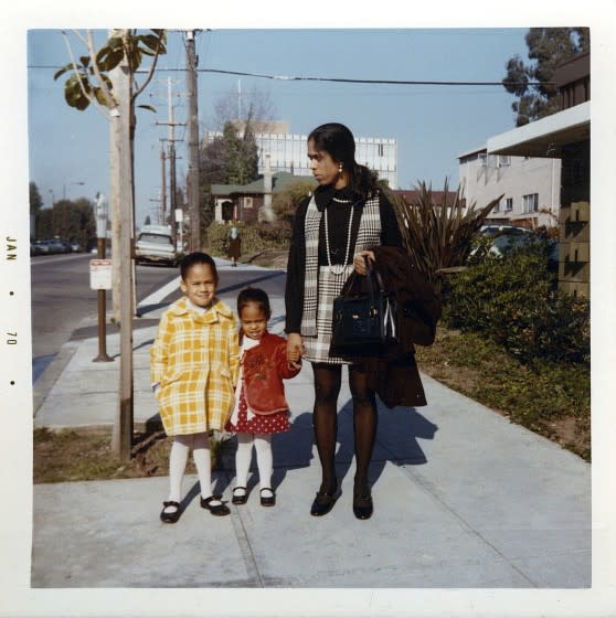 This January 1970 photo provided by the Kamala Harris campaign shows her, left, with her sister, Maya, and mother, Shyamala, outside their apartment in Berkeley, Calif.