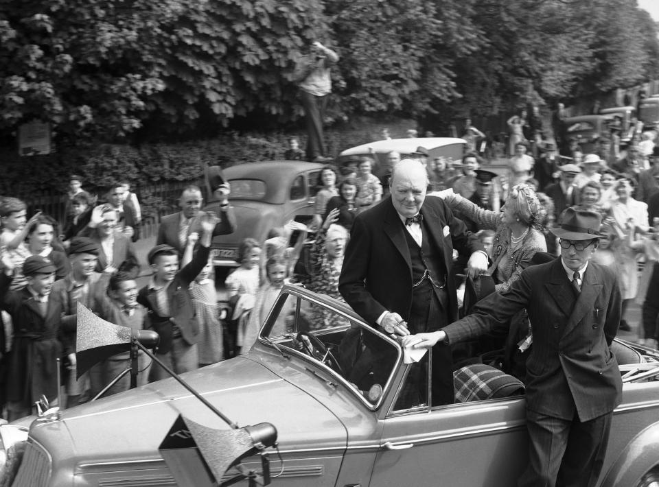 FILE - Britain's Prime Minister Winston Churchill, accompanied by his wife Clementine Churchill, tours his constituency, Woodford in England, July 5, 1945, urging people to vote in the upcoming general election. The upcoming general election on July 4, 2024 is widely expected to lead to a change of government for the first time in 14 years. According to many experts, it is expected to be one of the most consequential elections since the end of World War II. Churchill's Conservative Party suffered one of its biggest-ever defeats shortly after the victory over Nazi Germany in 1945. (AP Photo/File)
