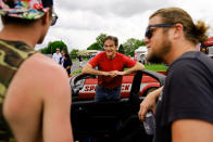 Mehmet Oz, a Republican candidate for U.S. Senate in Pennsylvania, meets with attendees during a visit to a car show in Carlisle, Pa., Saturday, May 14, 2022. (AP Photo/Matt Rourke)