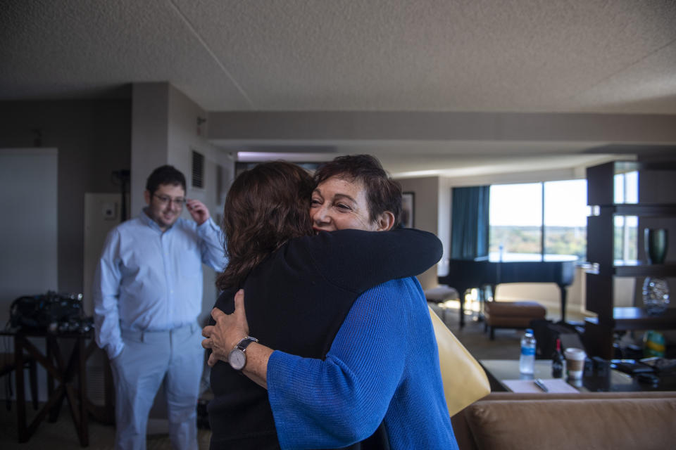 Anna Salton Eisen hugs Barbara Ringel upon arriving at a gathering for families of Holocaust survivors at a hotel in East Brunswick, N.J., on Sunday, Sept. 26, 2021. Eisen, who was going through documents left behind by her deceased father, found black-and-white photos of him and some other young Jewish men who’d been liberated by U.S. troops from a German concentration camp in 1945. Through months of dogged research, she identified many other descendants of her father’s fellow survivors, and arranged an emotional “reunion." (AP Photo/Brittainy Newman)