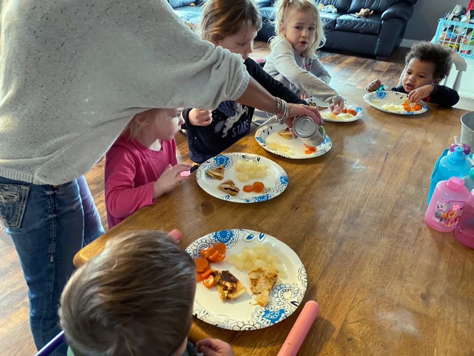 Wendy Tilma serves a lunch of hot chicken quesadillas and canned fruits and vegetables to the five kids she cares for in her Byron Center, Michigan, home during the school day.