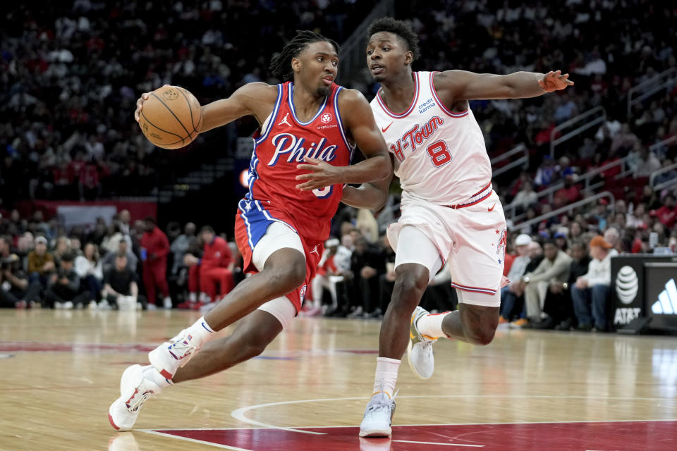 Philadelphia 76ers guard Tyrese Maxey, left, drives past Houston Rockets forward Jae'Sean Tate during the first half of an NBA basketball game Friday, Dec. 29, 2023, in Houston. (AP Photo/Eric Christian Smith)
