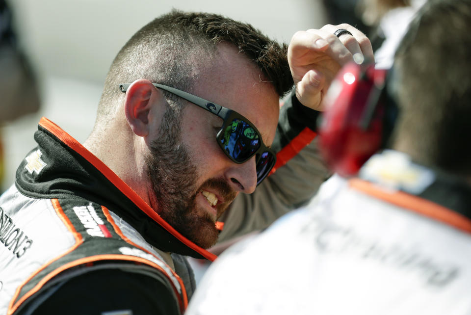 Austin Dillon, left, talks with crew members after his run during NASCAR auto race qualifying at Daytona International Speedway, Sunday, Feb. 9, 2020, in Daytona Beach, Fla. (AP Photo/John Raoux)