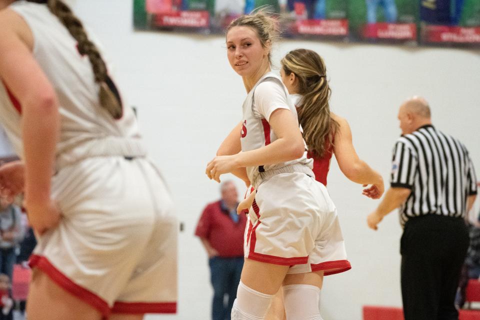 Rossville junior Emma Mitchell (4) looks back after sinking a three against Osage City in the second half of Tuesday's game.