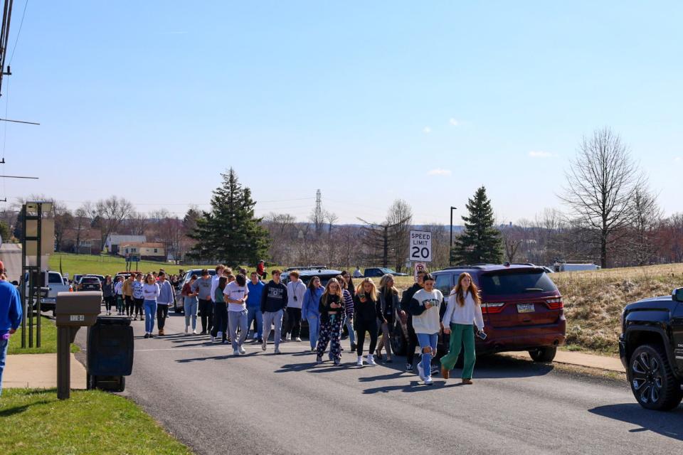 Children at Hopewell High School being led to a safe meeting spot March 29, 2023, after a lockdown was ordered because of an active shooter call that turned out to be a hoax.