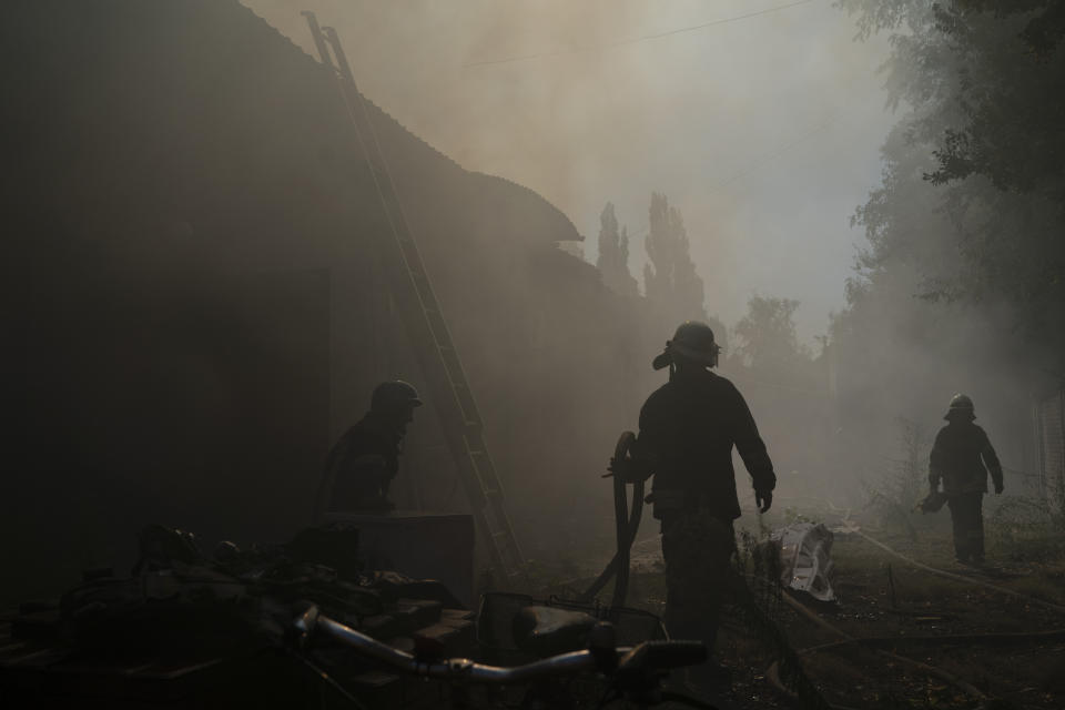 Firefighters work to extinguish a fire after a Russian attack that heavily damaged a building in Sloviansk, Donetsk region, eastern Ukraine, Monday, Aug. 29, 2022. (AP Photo/Leo Correa)