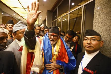 Newly elected Nepalese Prime Minister Sushil Koirala waves towards media personnel as he walks out from the Parliament after being elected as the Prime Minister in Kathmandu February 10, 2014. REUTERS/Navesh Chitrakar