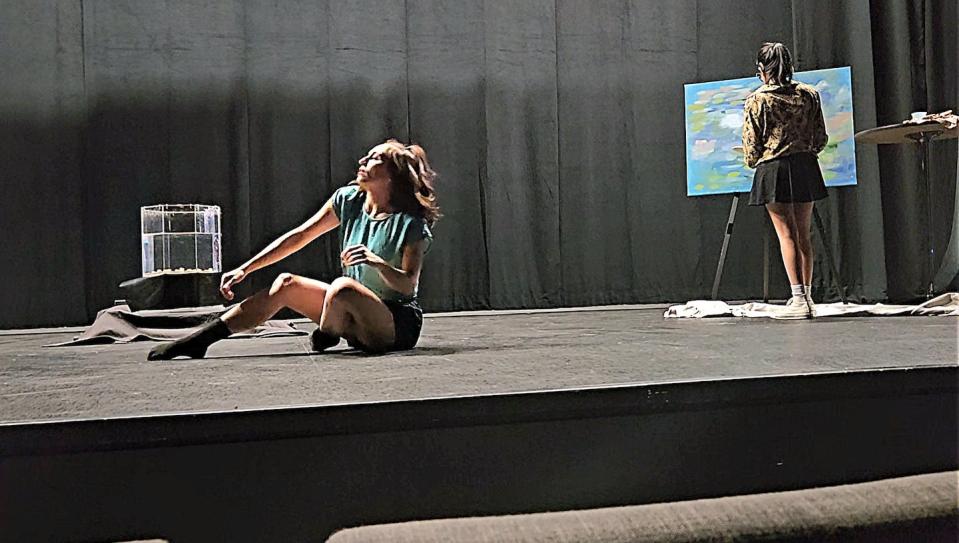 Choreographer Bella Dorado dances to sounds produced by the brainwaves of student Tanisha Chanda while she paints a waterscape. Francesco Fedele