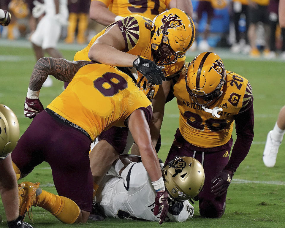 Arizona State defensive players Merlin Robertson (8) D.J Davidson (98) and Darien Butler (20) smother Colorado State tailback Alex Fontenot (8) during the first half of an NCAA college football game Saturday, Sept 25, 2021, in Tempe, Ariz. (AP Photo/Darryl Webb)